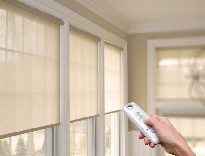 Electric roller blinds in the openings of the living room windows